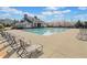 Enjoy the refreshing community pool with ample seating and a clubhouse under a bright blue sky at 441 Spring View Dr, Woodstock, GA 30188