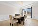 Bright dining room features modern chandelier, wainscoting, and neutral color palette at 441 Spring View Dr, Woodstock, GA 30188