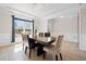 Well-lit dining room with modern chandelier, large windows, and neutral walls at 441 Spring View Dr, Woodstock, GA 30188