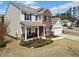 Inviting two-story home with brick and siding, front porch, landscaped garden, and attached two-car garage at 441 Spring View Dr, Woodstock, GA 30188