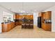 A kitchen with wood cabinets, bar stool seating, granite countertops, and black appliances at 441 Spring View Dr, Woodstock, GA 30188