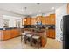 Modern kitchen boasts stainless appliances, dark counters and spacious island with barstools at 441 Spring View Dr, Woodstock, GA 30188