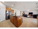 Open kitchen featuring wood cabinets, stainless appliances, tile floors, and a center island with barstool seating at 441 Spring View Dr, Woodstock, GA 30188