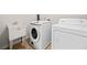 Practical laundry room with a sink, a washing machine, and a dryer for convenient household chores at 441 Spring View Dr, Woodstock, GA 30188