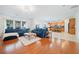Open concept living area featuring a blue sofa, hardwood floors, and island seating at 441 Spring View Dr, Woodstock, GA 30188
