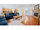 Bright living room with hardwood floors, stone fireplace, and open access to the kitchen at 441 Spring View Dr, Woodstock, GA 30188
