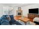 Comfortable living room with a stone fireplace, hardwood floors, and access to entry way at 441 Spring View Dr, Woodstock, GA 30188
