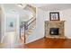 Inviting living room featuring a stone fireplace and beautiful hardwood floors at 441 Spring View Dr, Woodstock, GA 30188