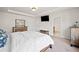 Spacious main bedroom with a tray ceiling features wooden furniture, carpet, and a large comfortable bed at 441 Spring View Dr, Woodstock, GA 30188