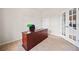 Office features a wooden desk, chair, and adjacent French doors to living space at 441 Spring View Dr, Woodstock, GA 30188
