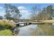Charming bridge over a serene pond, creating a picturesque and peaceful setting at 441 Spring View Dr, Woodstock, GA 30188