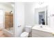 Well-lit bathroom featuring a toilet, sink, and tiled shower-tub combination at 1634 Ponce De Leon Ne Ave # 506, Atlanta, GA 30307