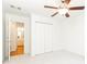Cozy bedroom showcasing a ceiling fan, closet, and access to the bathroom at 1634 Ponce De Leon Ne Ave # 506, Atlanta, GA 30307