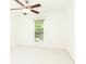 Minimalist bedroom featuring neutral walls, carpet, a ceiling fan, and a window with backyard views at 1634 Ponce De Leon Ne Ave # 506, Atlanta, GA 30307