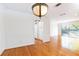 Dining room featuring hardwood floors, white walls, and view into the kitchen and living room at 1634 Ponce De Leon Ne Ave # 506, Atlanta, GA 30307