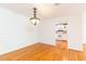 Dining room featuring hardwood floors, white walls, decorative light fixture, and view into kitchen at 1634 Ponce De Leon Ne Ave # 506, Atlanta, GA 30307