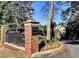 Community entrance with brick signage, mature trees, and street lamp at 1634 Ponce De Leon Ne Ave # 506, Atlanta, GA 30307