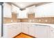 Well-lit kitchen featuring white cabinets, neutral tile backsplash, and light countertops at 1634 Ponce De Leon Ne Ave # 506, Atlanta, GA 30307
