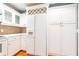 Updated kitchen featuring white cabinets, countertops, and a built-in wine rack above the refrigerator at 1634 Ponce De Leon Ne Ave # 506, Atlanta, GA 30307