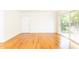 Bright and airy living room featuring hardwood floors, white walls, and a sliding glass door at 1634 Ponce De Leon Ne Ave # 506, Atlanta, GA 30307