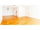Open living room with hardwood floors and crown molding leading to the kitchen at 1634 Ponce De Leon Ne Ave # 506, Atlanta, GA 30307