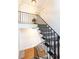 Classic stairway featuring black iron railings, white wainscoting, and carpeted steps at 1634 Ponce De Leon Ne Ave # 506, Atlanta, GA 30307