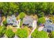 Aerial view of a brick home featuring a circular driveway, mature landscaping, and an in-ground pool at 2644 Nutwood Trce, Duluth, GA 30097