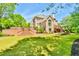 Large backyard with tiered brick patio, landscaped garden, and stairs to a raised terrace at 2644 Nutwood Trce, Duluth, GA 30097