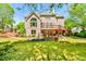 Expansive backyard boasting a tiered brick patio, lush lawn, and mature landscaping at 2644 Nutwood Trce, Duluth, GA 30097