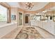 This bathroom features dual sinks, a large mirror, a chandelier, a tub, a walk-in shower, and tan wallpaper at 2644 Nutwood Trce, Duluth, GA 30097