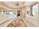 This bathroom features dual sinks, a large mirror, a chandelier, a tub, and neutral wallpaper at 2644 Nutwood Trce, Duluth, GA 30097