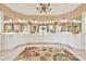 This bathroom features a U-shaped vanity with dual sinks, a large mirror, and a chandelier at 2644 Nutwood Trce, Duluth, GA 30097