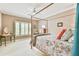 Bedroom featuring a four-poster bed and shuttered windows for ample natural light at 2644 Nutwood Trce, Duluth, GA 30097