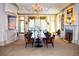 Elegant dining room with large windows, a fireplace, and a long table with chairs at 2644 Nutwood Trce, Duluth, GA 30097