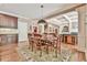 Dining area flowing to kitchen and living spaces with hardwood floors at 2644 Nutwood Trce, Duluth, GA 30097