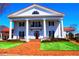 Elegant white home with a red roof, stately columns, and a brick pathway at 2644 Nutwood Trce, Duluth, GA 30097
