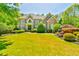 Beautiful home with manicured lawn, mature landscaping, and a symmetrical front facade at 2644 Nutwood Trce, Duluth, GA 30097