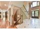 This home's foyer features hardwood floors, a staircase, columns, and a front door at 2644 Nutwood Trce, Duluth, GA 30097