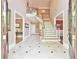 Grand foyer featuring marble flooring, a winding staircase, and views of the dining and living rooms at 2644 Nutwood Trce, Duluth, GA 30097