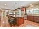 Open kitchen with a large island, stainless appliances, granite counters, and hardwood floors at 2644 Nutwood Trce, Duluth, GA 30097