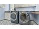 Laundry room featuring a sink, countertop, cabinets, and modern washer and dryer units at 2644 Nutwood Trce, Duluth, GA 30097