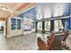 This living room features a blue ceiling, built-in shelves, tile floors, and a wall of windows at 2644 Nutwood Trce, Duluth, GA 30097