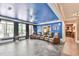 This living room features a blue ceiling, a ceiling fan, tile floors, and a wall of windows at 2644 Nutwood Trce, Duluth, GA 30097