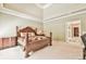 This main bedroom boasts tray ceilings, a large wooden bed frame, a carpeted floor, and neutral-colored walls at 2644 Nutwood Trce, Duluth, GA 30097