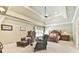 Cozy bedroom with sitting area, tray ceiling, and classic wooden furniture at 2644 Nutwood Trce, Duluth, GA 30097
