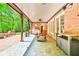 Inviting covered patio featuring brick flooring, ample seating, and a charming brick exterior at 2644 Nutwood Trce, Duluth, GA 30097