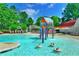 Community pool featuring a splash pad, water features, and ample seating at 2644 Nutwood Trce, Duluth, GA 30097