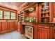 This built in wet bar features plentiful shelving, granite counters, and a wine cooler at 2644 Nutwood Trce, Duluth, GA 30097