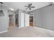 Large carpeted bedroom featuring ceiling fan, ensuite bathroom, and several closets at 3338 Peachtree Ne Rd # 1010, Atlanta, GA 30326