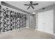 Spacious carpeted bedroom with ceiling fan and city-themed wallpaper at 3338 Peachtree Ne Rd # 1010, Atlanta, GA 30326